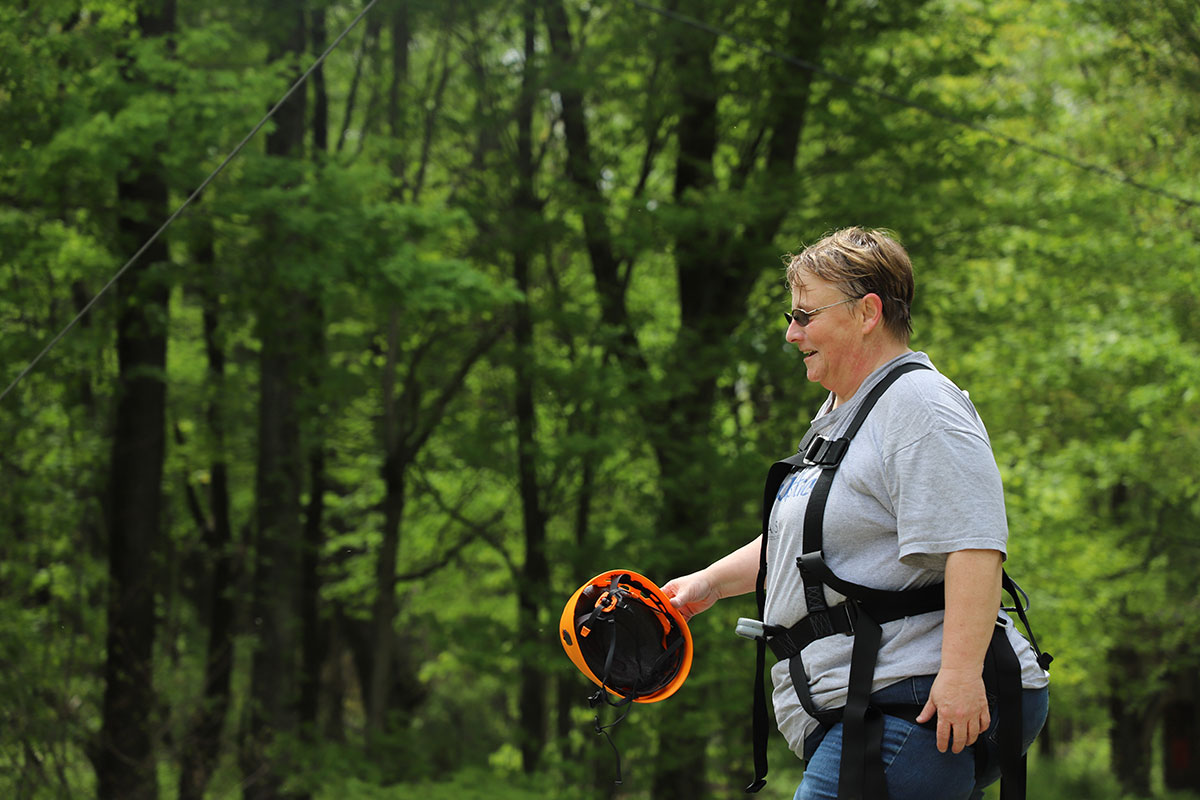 Woman smiling after doing the zip line at a retreat