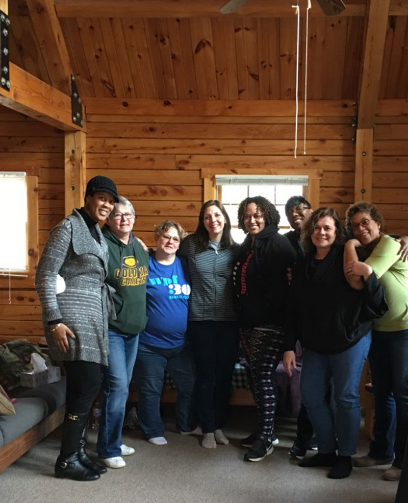 Women in a cabin pose from a Deep Water Retreat