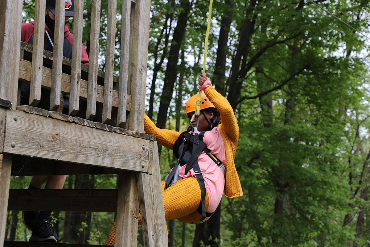 Ambie climing the zip line