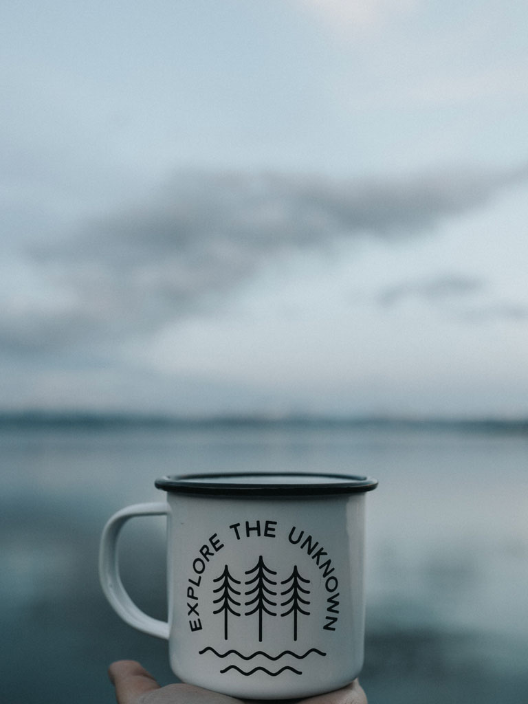 Cup of tea in front of a lake