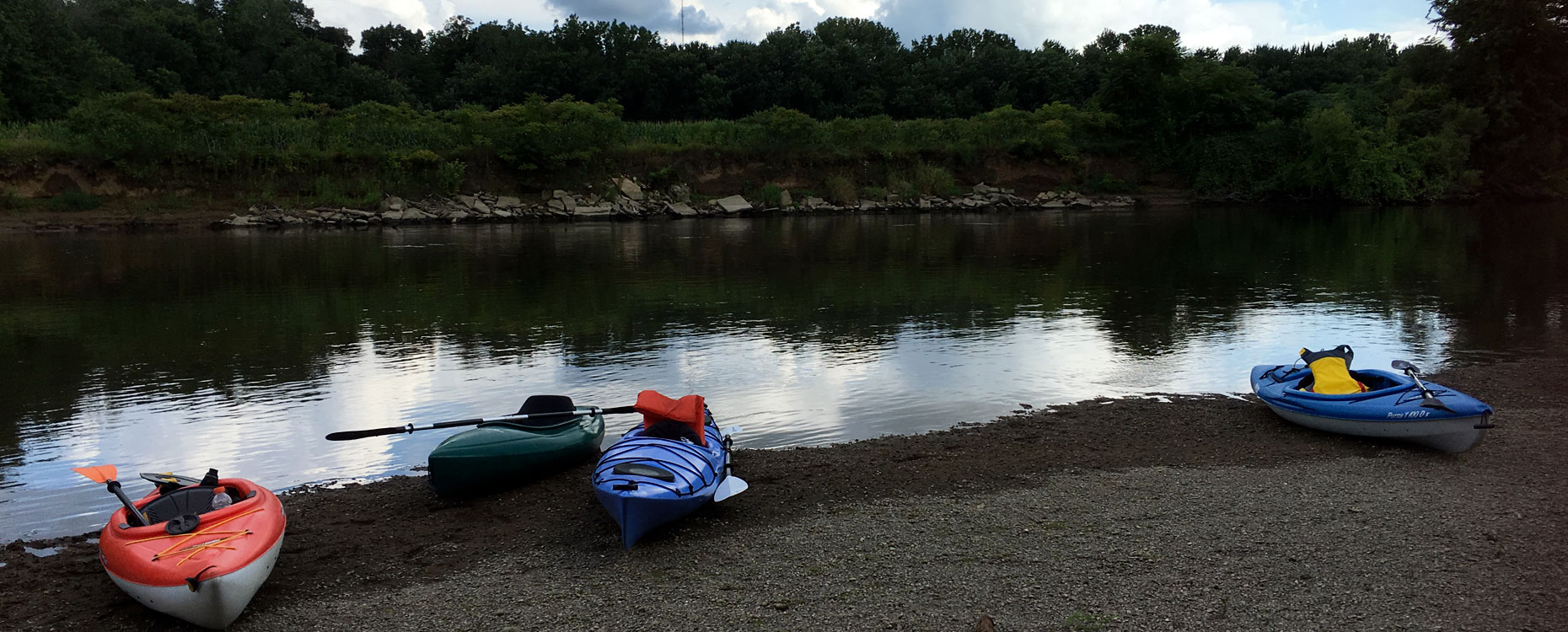 beached kayaks, a Deep Water retreat stops for a lunch break along the river for conversation, inspiration from Scripture, and nourishment